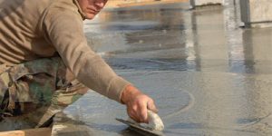 man smoothing out concrete